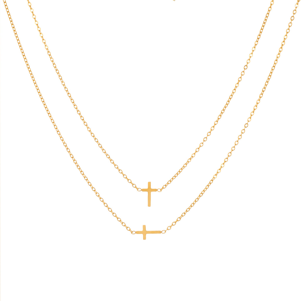 Two delicate gold chain necklaces with small cross pendants, displayed against a solid white background.